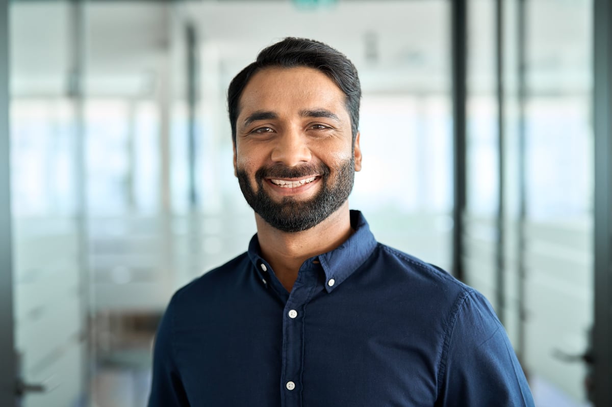 Happy bearded man customer smiling looking at camera