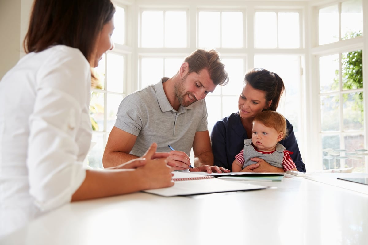 Family with financial advisor reviewing solar financing at home